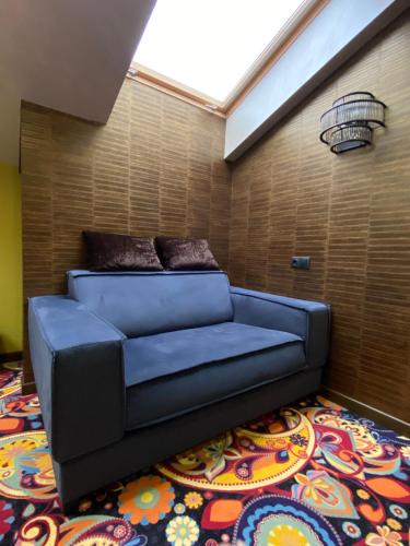 a blue couch in a room with a rug at ArtApart Vozdvigenka in Kyiv