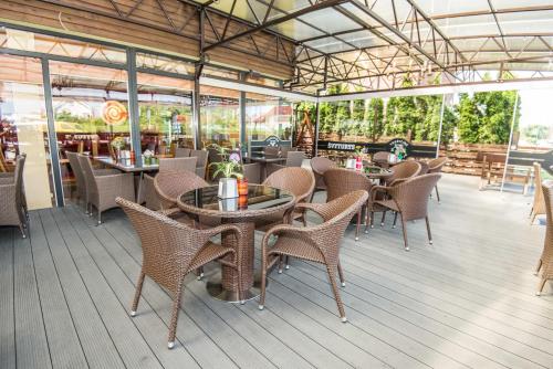 a restaurant with tables and chairs on a deck at Tako Baras in Klaipėda