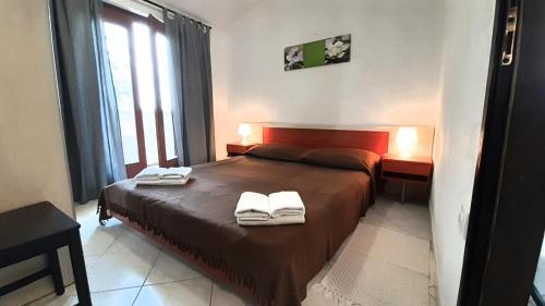 a bedroom with a bed with two towels on it at Apartments Nadia Sokolić in Nerezine