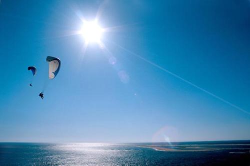 two kites flying in the sky over the ocean at Holiday Inn Bordeaux Sud - Pessac by IHG in Pessac
