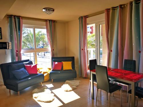 a living room with a dining room table and chairs at Beautiful Apartment in La Manga in San Javier