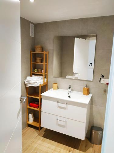 a bathroom with a white sink and a mirror at Apartamento Cruise Views in Almuñécar