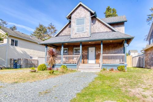 a house with a porch and a driveway at Pine Beach House in Rockaway Beach