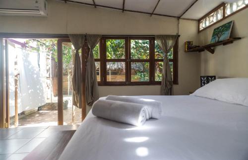 a bedroom with a bed and a window at Casa Marimba in La Laguna