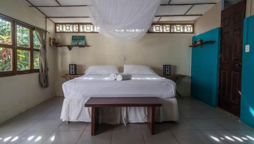 a bedroom with a white bed and white walls at Casa Marimba in La Laguna