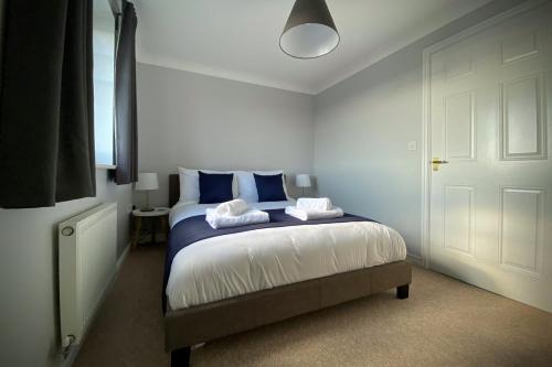 a bedroom with a bed with two pillows on it at Appleby Darlington Two in Darlington