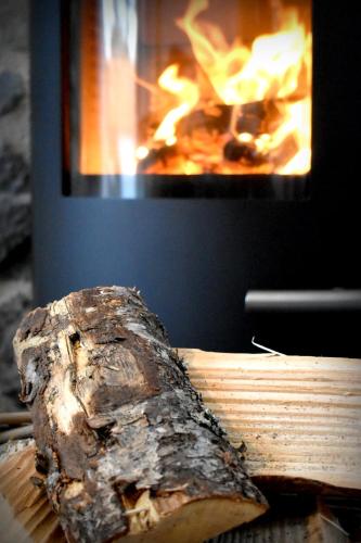 a piece of meat on a cutting board in front of a fire at The Auld Reekie in Barbaraville