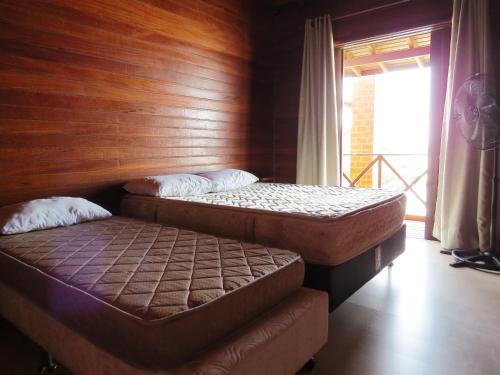 Un pat sau paturi într-o cameră la Moradas da Lu