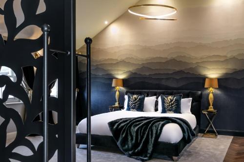 a bedroom with a bed with a wall mural at The Old Hay Shed in Cartmel