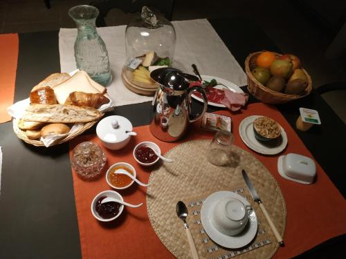 a table with a plate of bread and fruit on it at Rue du Château in Tarascon