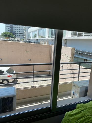 a view from a window of a balcony with a car at Olivos Suites in Olivos