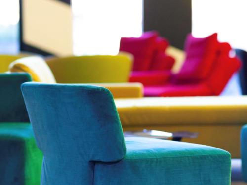 a group of colorful chairs in a room at ibis Styles Basel City in Basel