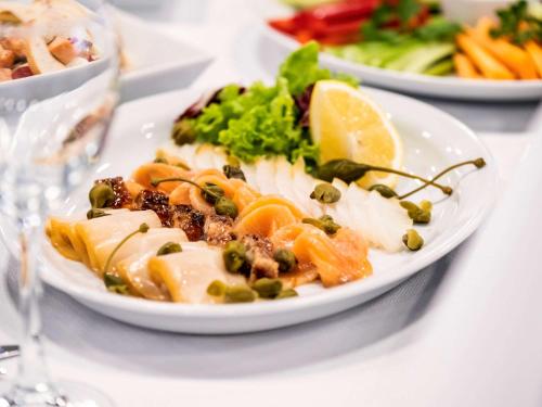 a white plate of food on a white table at Mercure Kyiv Congress in Kyiv