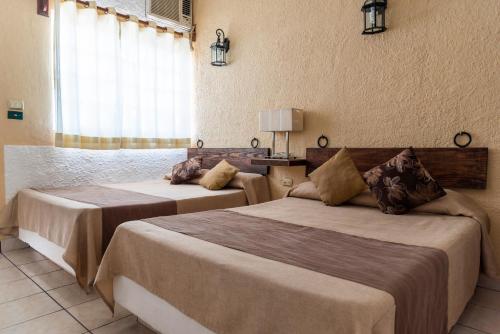 Cama o camas de una habitación en Hotel Villas Santa Ana