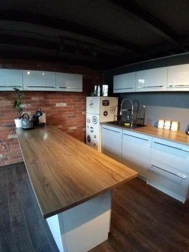 a kitchen with a wooden counter top in a room at LOFT 314 in Żyrardów
