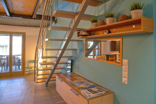 a kitchen with a spiral staircase in a house at Villa Ambrosia, beach house, Platanidia, Pelion in Platanidia
