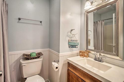 a bathroom with a sink and a toilet and a mirror at South Carolina Condo with Beach Access, Near Golfing in Hilton Head Island