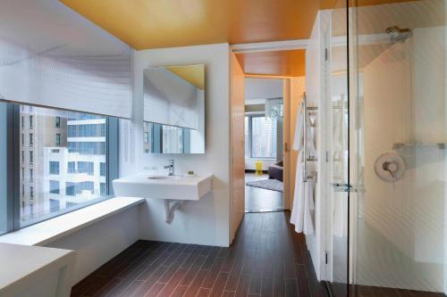 a bathroom with a white sink and a shower at The Washington Hotel NYC in New York