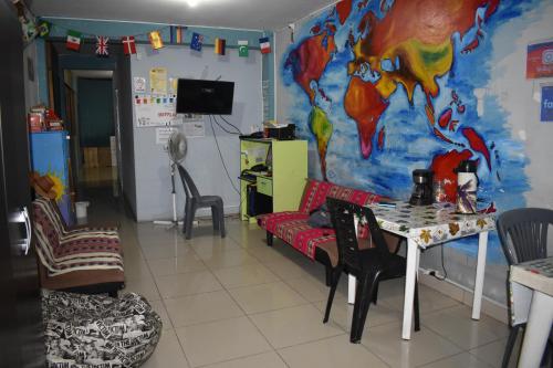 a living room with a couch and a table at Passion Hostel - Lima Airport in Lima