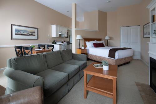 a living room with a couch and a bed at Rivertide Suites in Seaside