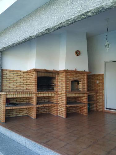 a brick fireplace in a living room at MARINHO'S - Vivenda Marinho in Porto