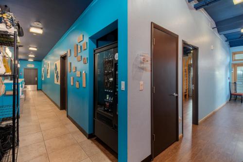 a hallway with blue walls and a hallway with doors at The Bunkhouse in Minturn