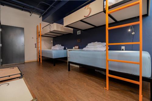 a room with two bunk beds and a desk at The Bunkhouse in Minturn