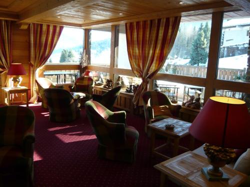 a room with chairs and tables and a large window at Aux Ducs de Savoie in Combloux