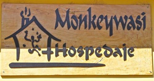 a wooden sign with aievalievalieval at Monkeywasi Climbing Hostel in Huaraz