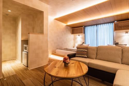 a living room with a couch and a table at GRAND BASE Mojiko Ekimae in Kitakyushu