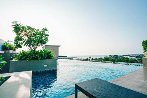 a swimming pool on the side of a building at Sweet Seaview flr6 with toproop pool flr7 at The BluX Bangsaen in Bangsaen
