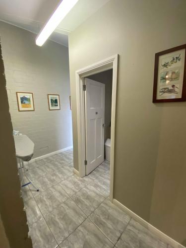 a bathroom with a sink and a toilet in a room at Edinburgh Gallery Bed & Breakfast in Hobart