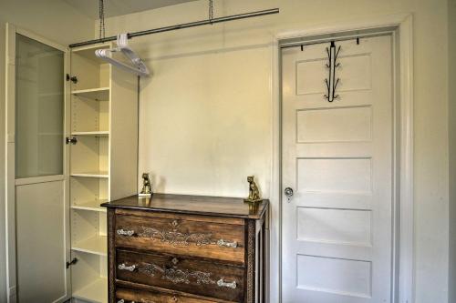 a closet with a wooden dresser next to a door at Pet-Friendly Carrboro Cottage Less Than 1 Mi to Carr Mall in Carrboro