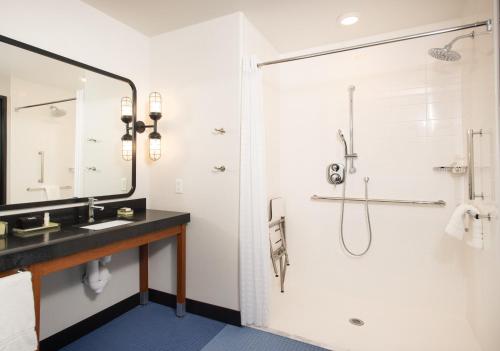 a bathroom with a shower and a sink at Hotel Indigo - Madison Downtown by IHG in Madison