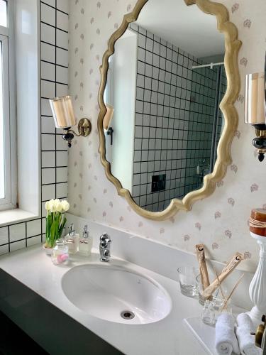 a bathroom with a sink and a mirror at Red Thread Calangute in Calangute