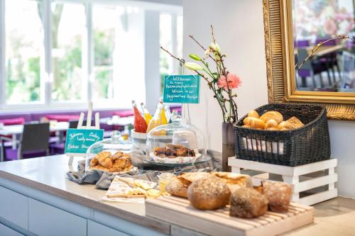 a buffet with bread and pastries on a table at Hotel Indigo - Dusseldorf - Victoriaplatz by IHG in Düsseldorf