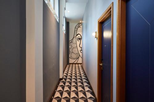 a hallway with a painting on the wall at Hotel Indigo The Hague - Palace Noordeinde by IHG in The Hague