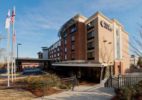 a large building with a clock on the side of it at Hotel Indigo Atlanta Airport College Park, an IHG Hotel in Atlanta