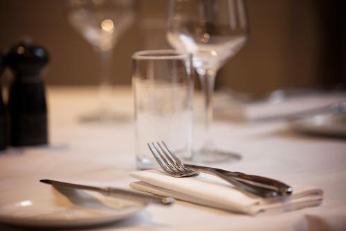a table with a fork and a glass on it at Hotel Indigo Glasgow by IHG in Glasgow