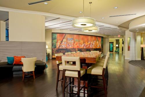 a dining room with a table and some chairs at Hotel Indigo Atlanta Airport College Park by IHG in Atlanta
