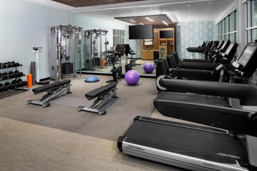 a gym with treadmills and exercise equipment in it at Hotel Indigo Gainesville-Celebration Pointe by IHG in Gainesville