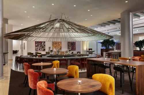 a large chandelier in a restaurant with tables and chairs at Hotel Indigo Atlanta Downtown by IHG in Atlanta