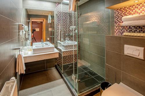 a bathroom with two sinks and a shower at Ramada Ulaanbaatar City Center in Ulaanbaatar