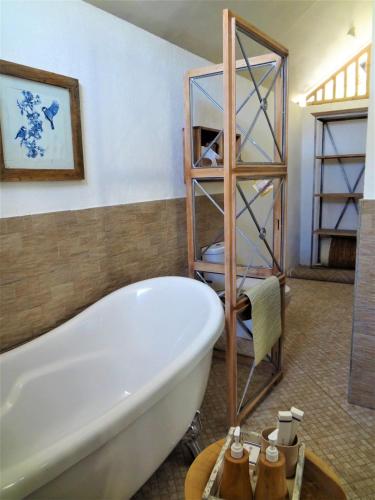a bathroom with a bath tub in a room at Le Kekeri Villas Collection in Mataram