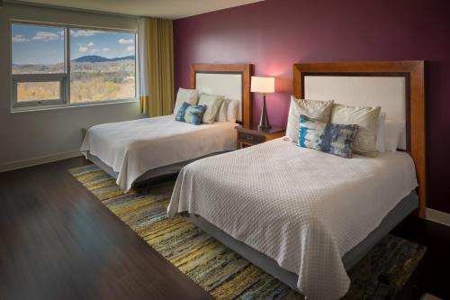 a hotel room with two beds and a window at Hotel Indigo Asheville Downtown, an IHG Hotel in Asheville