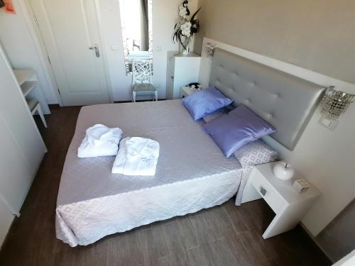 a bedroom with a bed with two towels on it at Hotel Nordic in Bellaria-Igea Marina