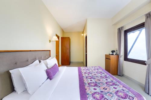a hotel room with a large bed and a window at Mount Himalayan Hotel in Gangtok