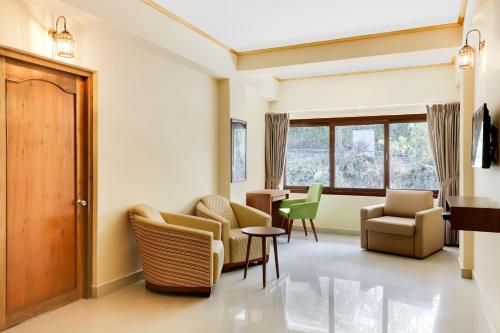 a waiting room with chairs and a table at Mount Himalayan Hotel in Gangtok