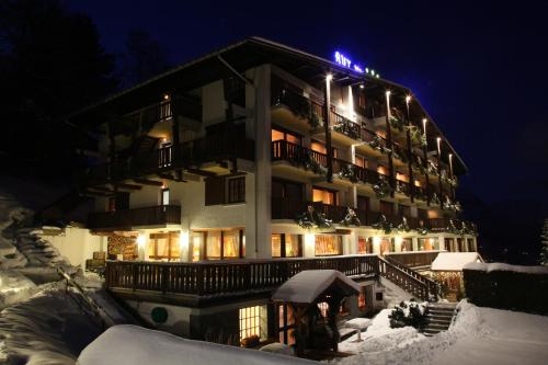 a building in the snow at night at Aux Ducs de Savoie in Combloux