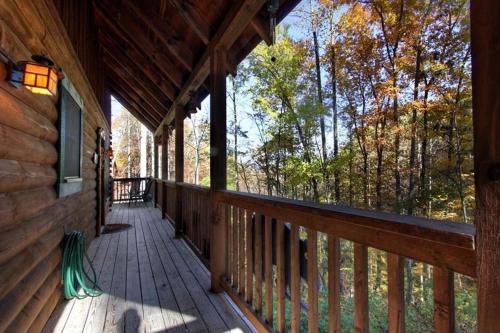 a porch of a cabin with a view of the woods at Forest Fling Cabin in McCookville